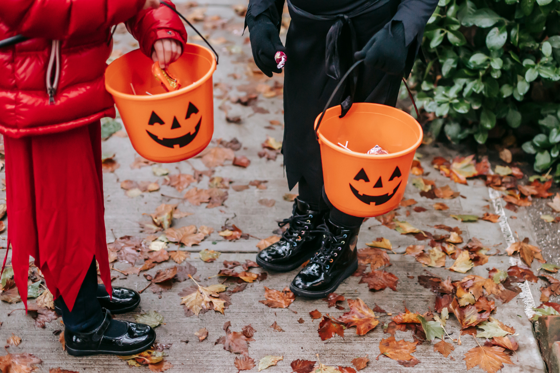 Children carrying jack-o'-lantern buckets for Halloween trick-or-treating
